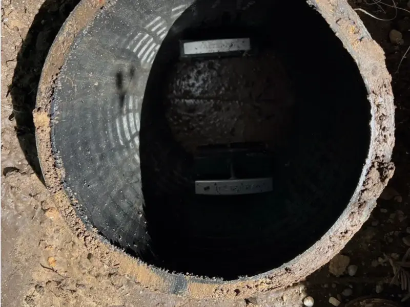 Looking down a septic riser to the tank below