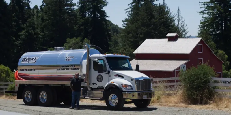 Ryan's truck parked by a red barn on a rural property