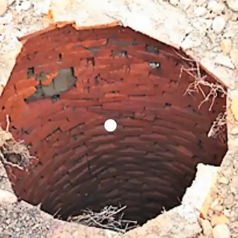 A brick-lined cesspool