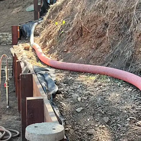Suction hose run down a hillside to the tank