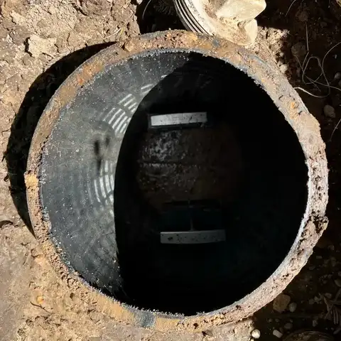 An open septic tank, pumped down for inspection