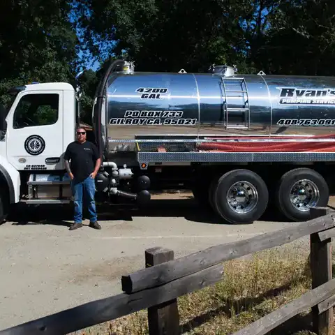 The truck parked at a job beside a split-rail fence