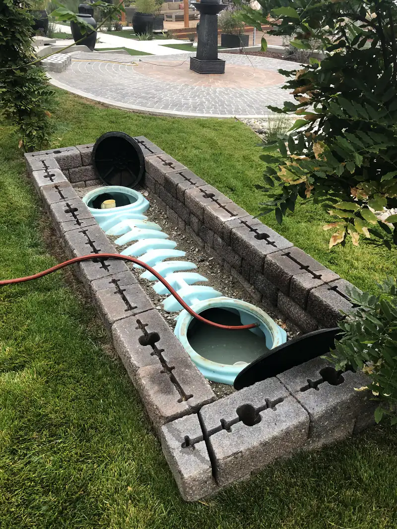 Septic tank risers exposed in a trench during an inspection