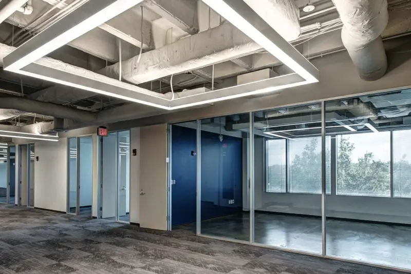 Glass-front offices along a finished corridor