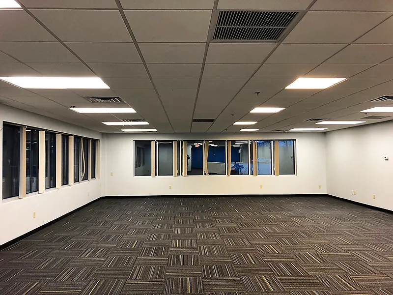 Empty finished office space with new carpet, ceiling and lighting